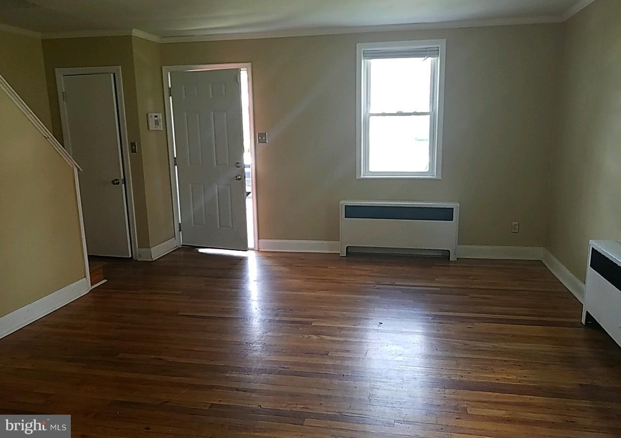 8539 Willow Oak Road Baltimore, MD 21234 - Photo 8 of 30 an empty room with wooden floor and windows