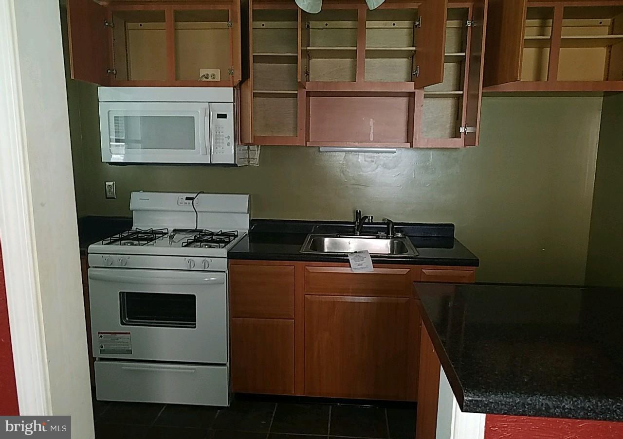 8539 Willow Oak Road Baltimore, MD 21234 - Photo 9 of 30 a kitchen with a stove and a microwave