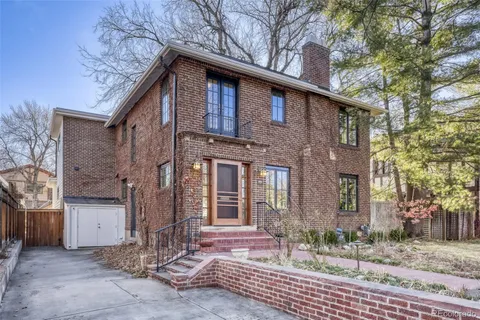 a backyard of a house with lots of green space and fountain