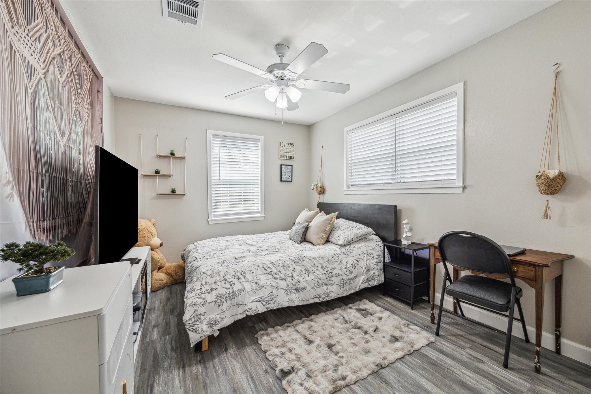 3808 Cochran Street Houston, TX 77009 - Photo 12 of 14 a bedroom with a bed and a chandelier