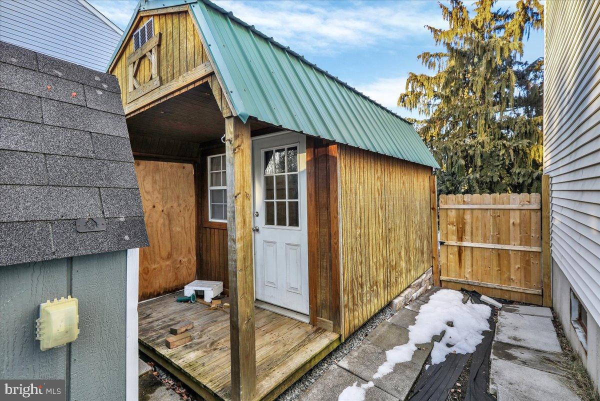 4020 Grant Street Reading, PA 19606 - Photo 49 of 49 Charming shed with rustic appeal and greenery.