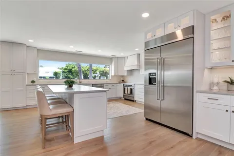 a kitchen with a sink window and cabinets