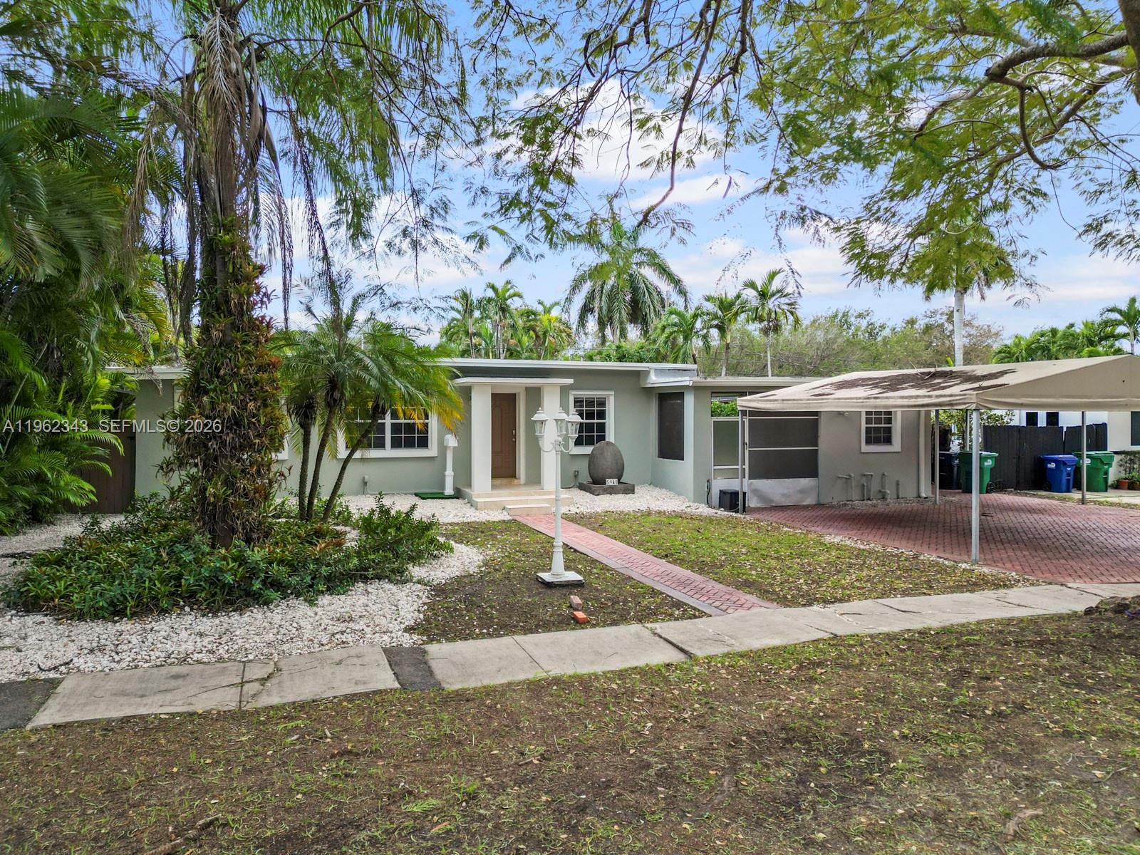 5940 Southwest 47th Street Miami, FL 33155 - Photo 1 of 53 front view of a house with a patio