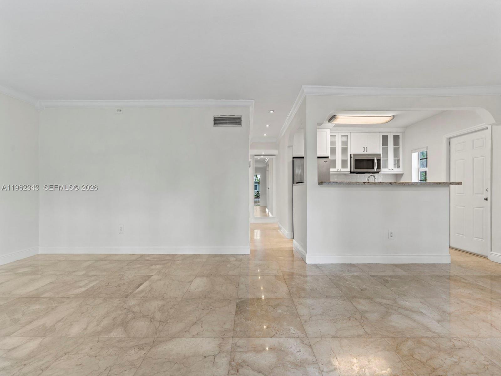 5940 Southwest 47th Street Miami, FL 33155 - Photo 12 of 53 a view of a kitchen with refrigerator and white cabinets