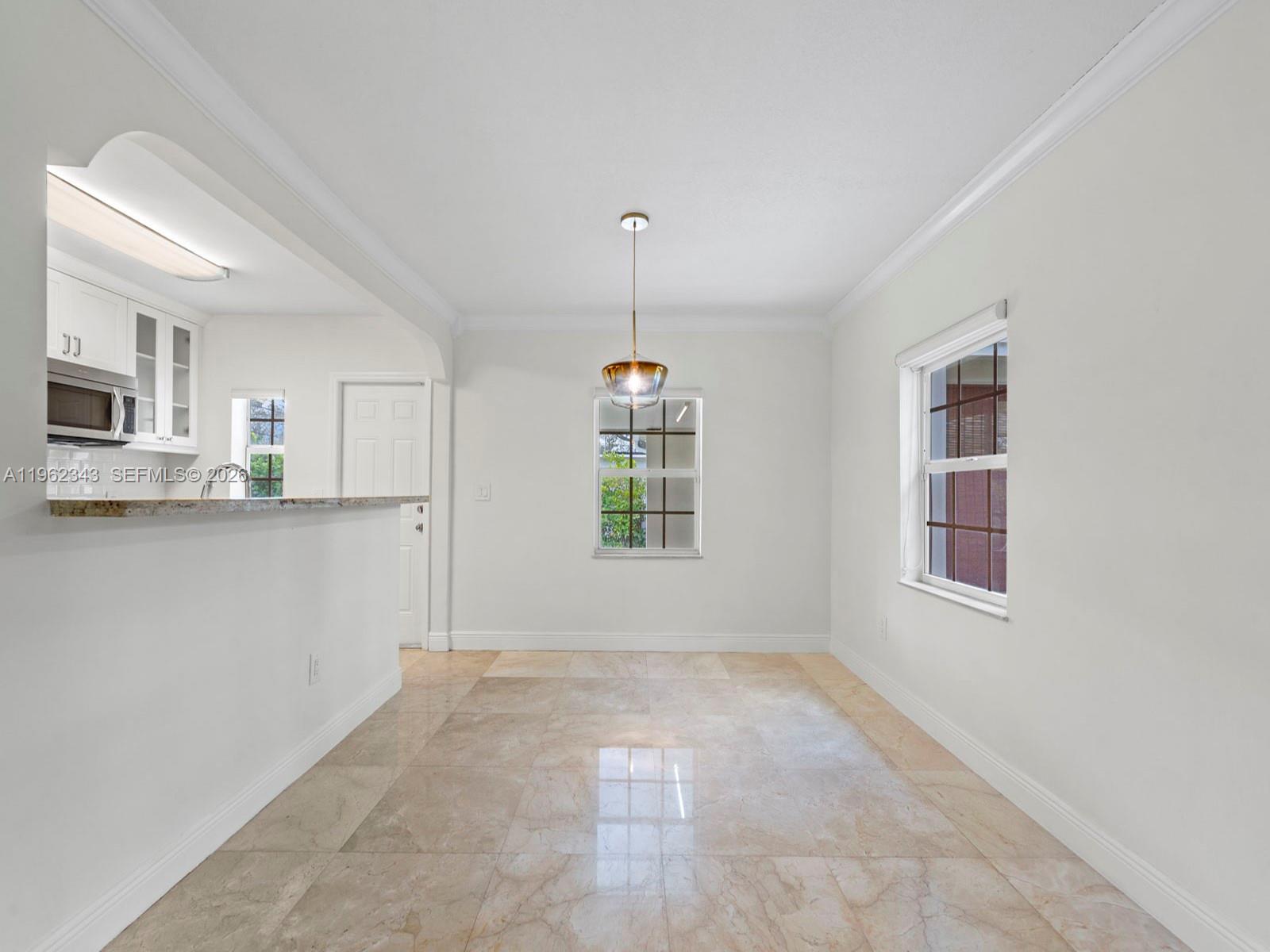 5940 Southwest 47th Street Miami, FL 33155 - Photo 14 of 53 a view of a kitchen with wooden cabinet and a window
