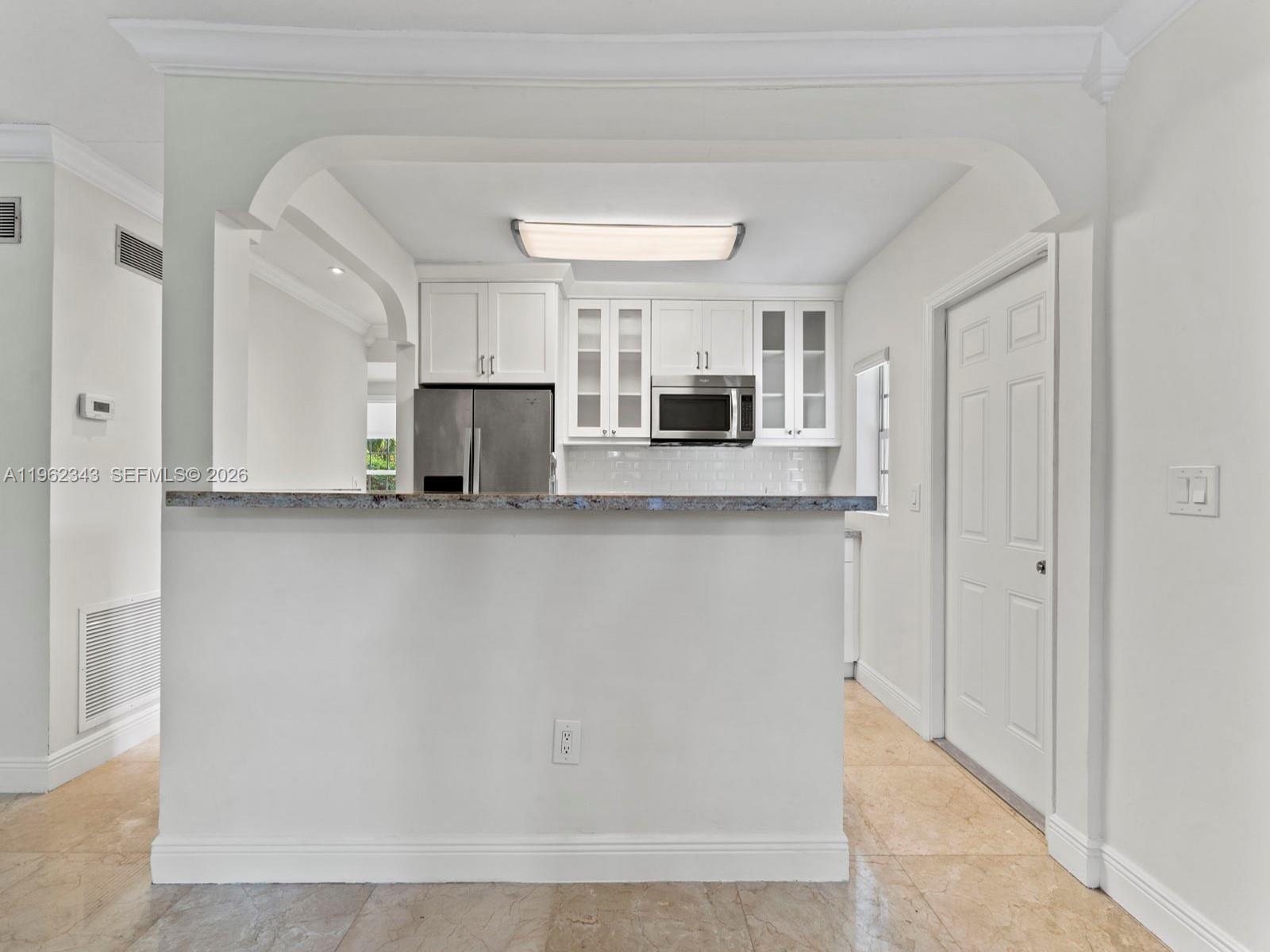 5940 Southwest 47th Street Miami, FL 33155 - Photo 16 of 53 a view of kitchen with microwave and cabinets