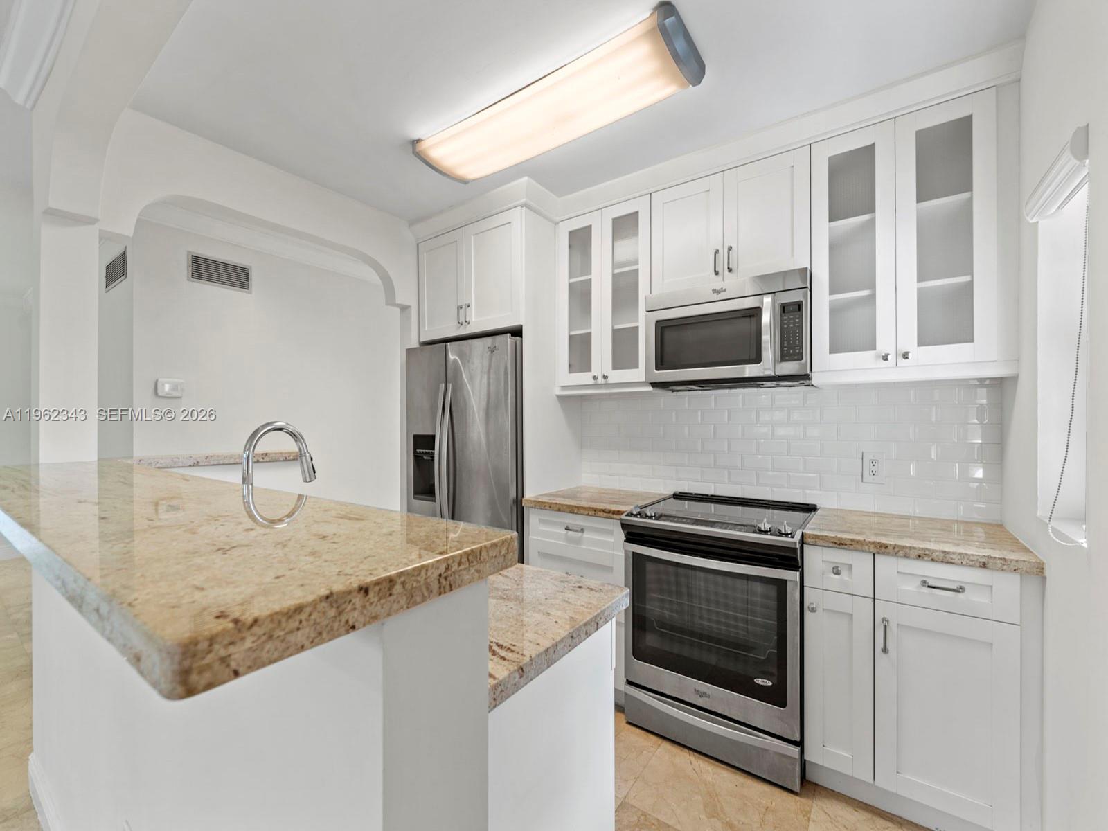 5940 Southwest 47th Street Miami, FL 33155 - Photo 17 of 53 a kitchen with stainless steel appliances granite countertop a kitchen island a stove and a sink