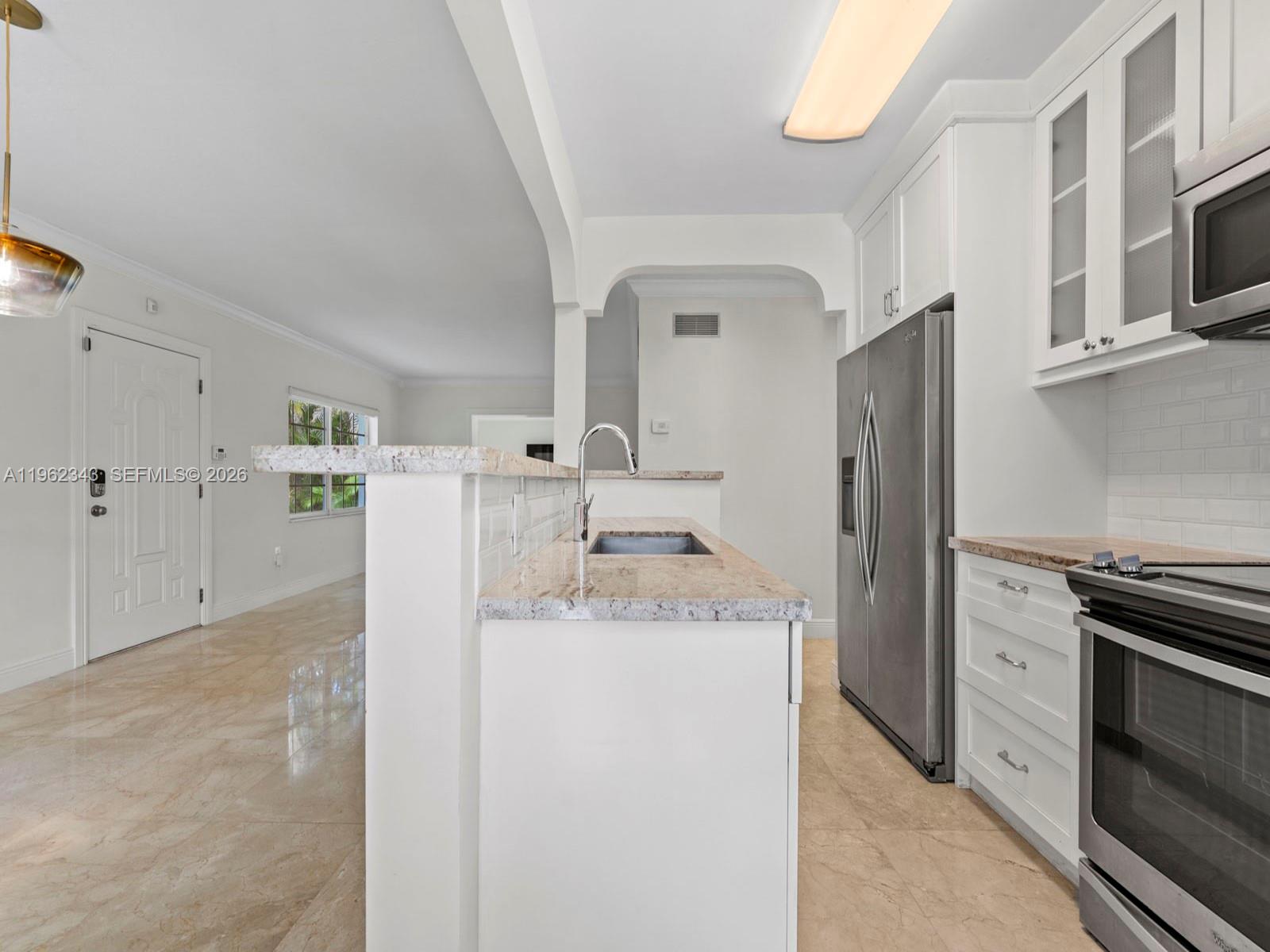 5940 Southwest 47th Street Miami, FL 33155 - Photo 18 of 53 a kitchen with stainless steel appliances granite countertop a refrigerator a stove and a sink