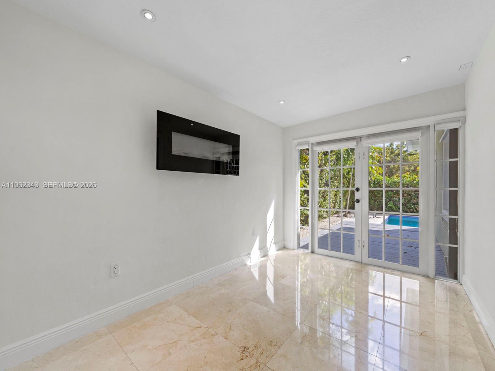 5940 Southwest 47th Street Miami, FL 33155 - Photo 26 of 53 a view of a livingroom with a flat screen tv