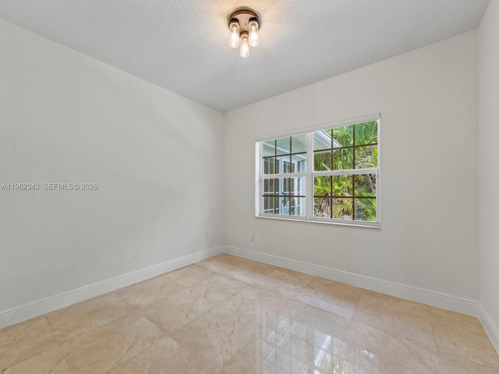 5940 Southwest 47th Street Miami, FL 33155 - Photo 30 of 53 an empty room with a window