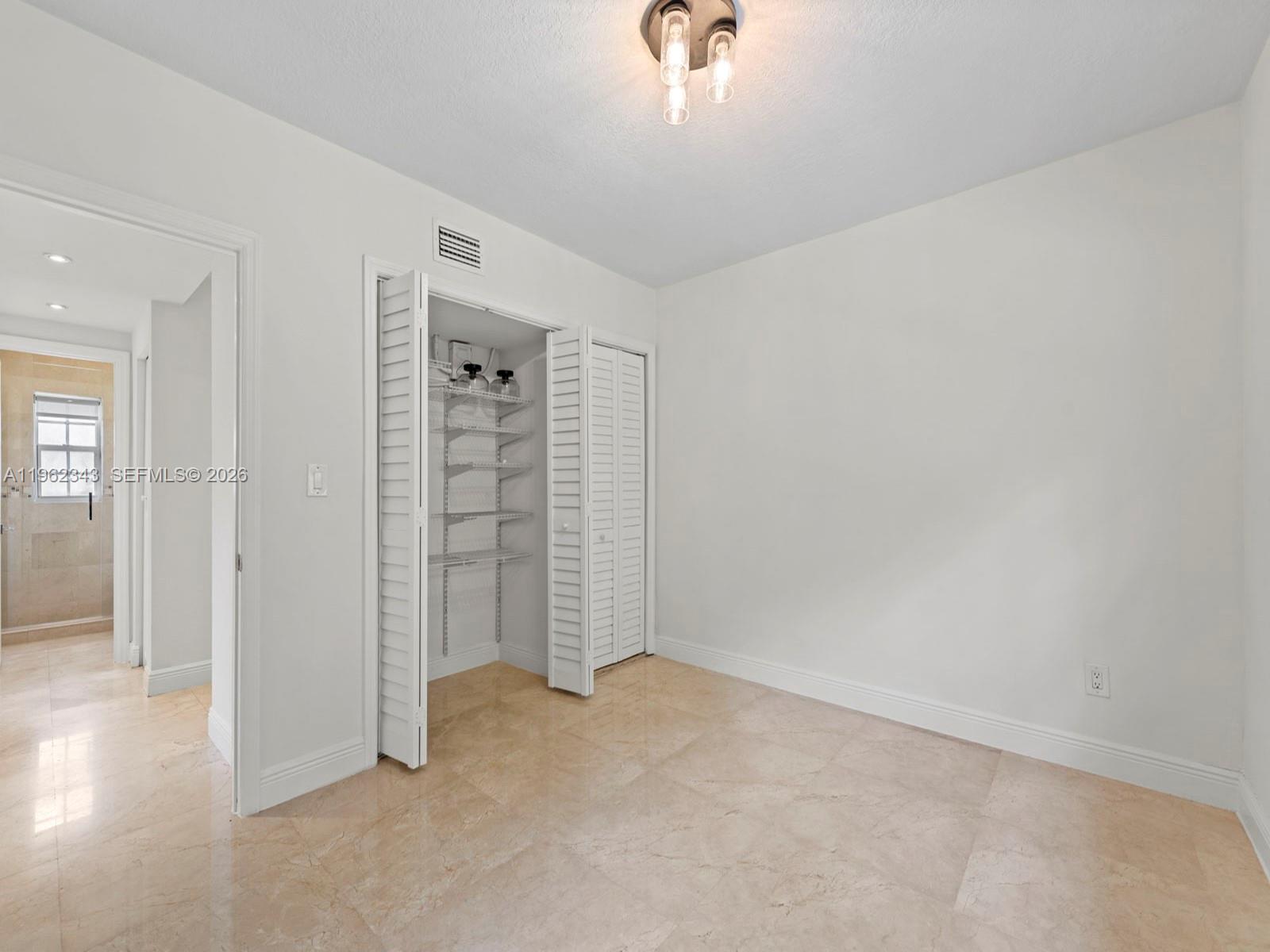 5940 Southwest 47th Street Miami, FL 33155 - Photo 31 of 53 an empty room with windows and closet
