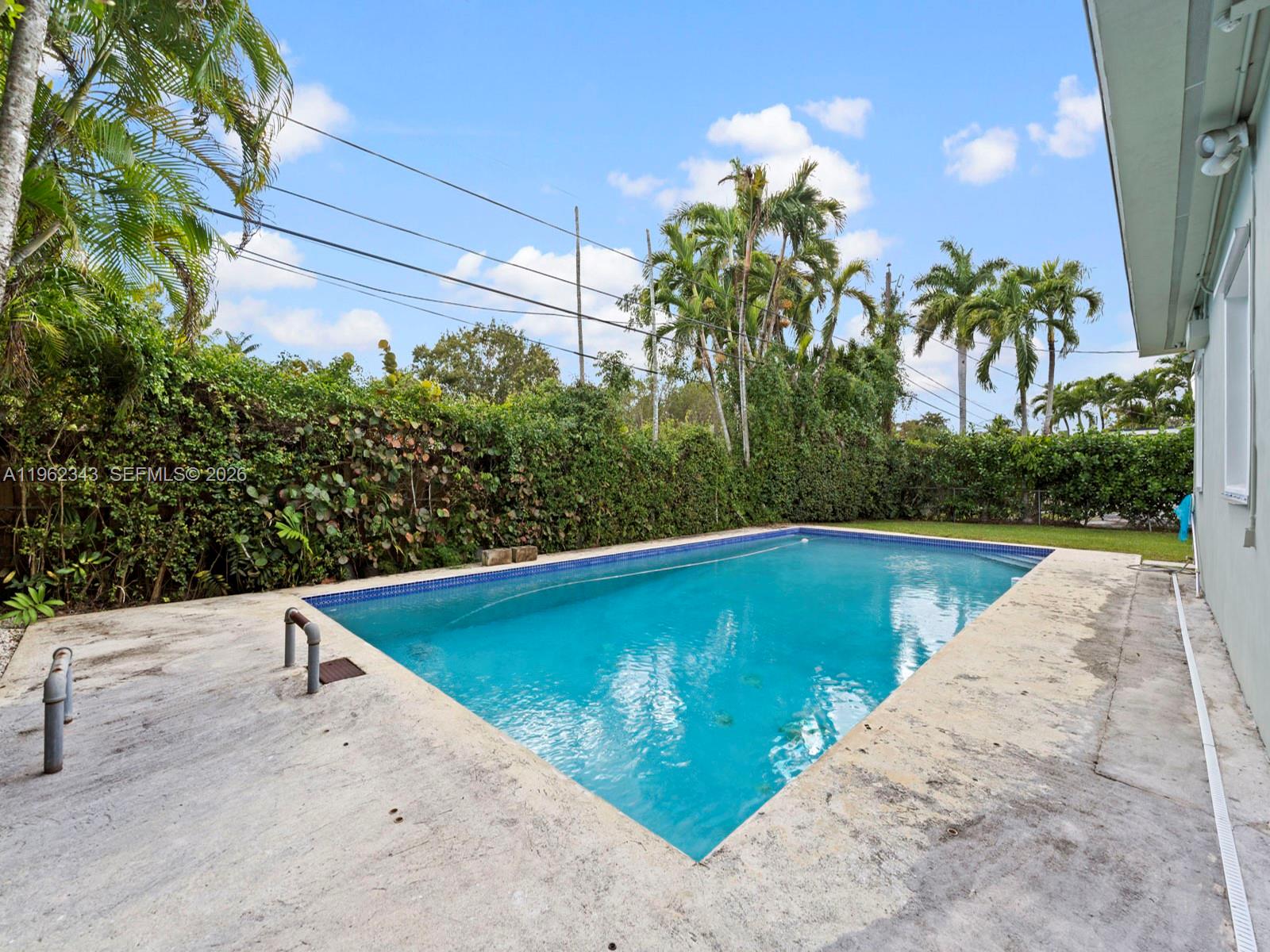 5940 Southwest 47th Street Miami, FL 33155 - Photo 40 of 53 a view of a swimming pool with a yard