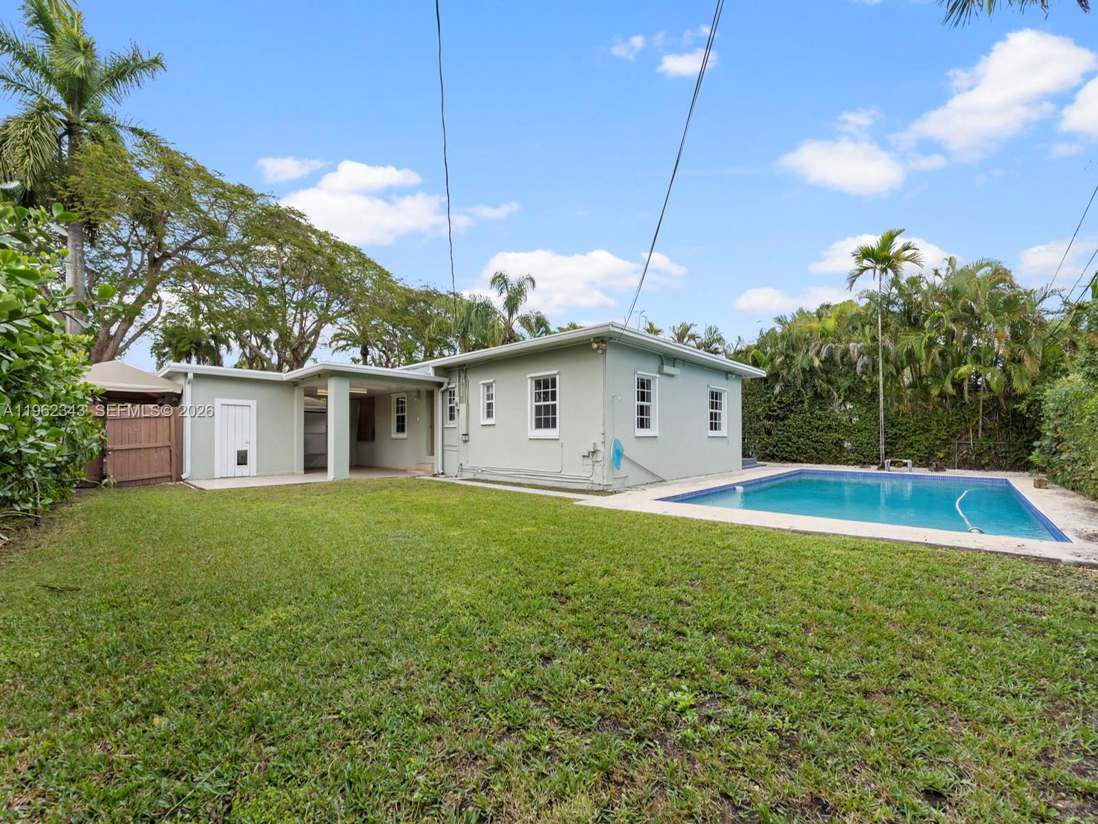 5940 Southwest 47th Street Miami, FL 33155 - Photo 45 of 53 a view of a house with a backyard and a tree