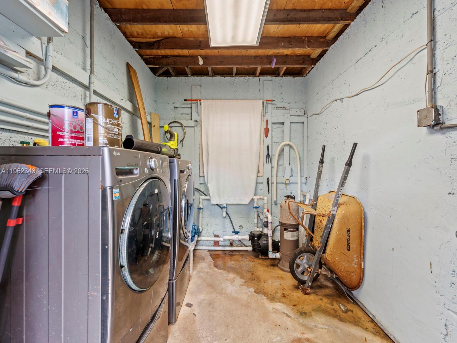 5940 Southwest 47th Street Miami, FL 33155 - Photo 49 of 53 a view of a storage and utility room with washer and dryer