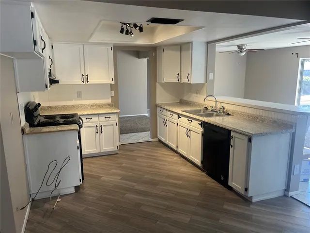 a kitchen with stainless steel appliances granite countertop a stove and a sink