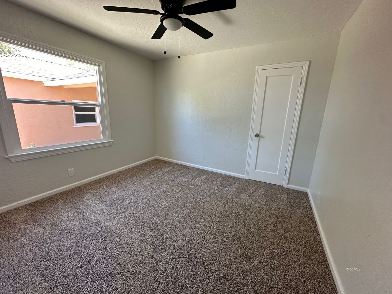 300 North Sanders Street Ridgecrest, CA 93555 - Photo 10 of 15 an empty room with a window and a ceiling fan