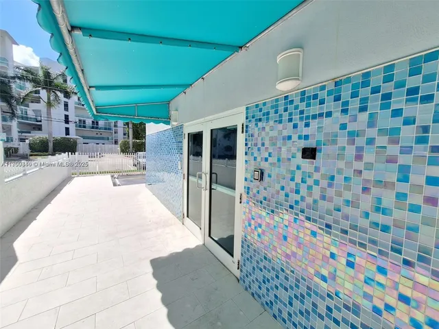 a lobby with a rug and a white door