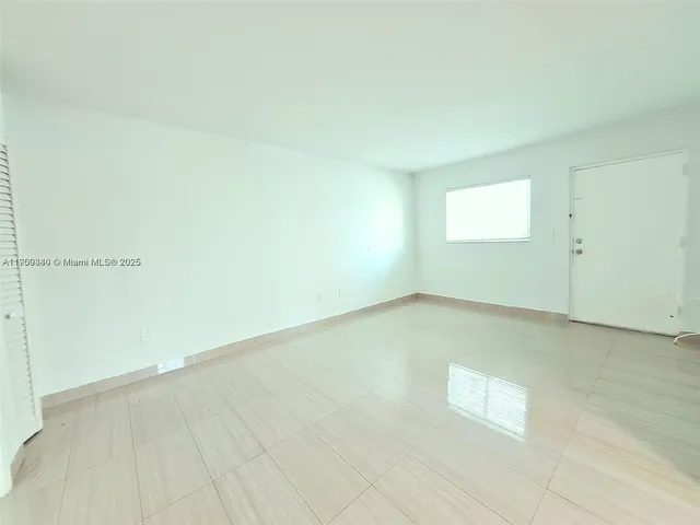 a view of a room with wooden floor and cabinet