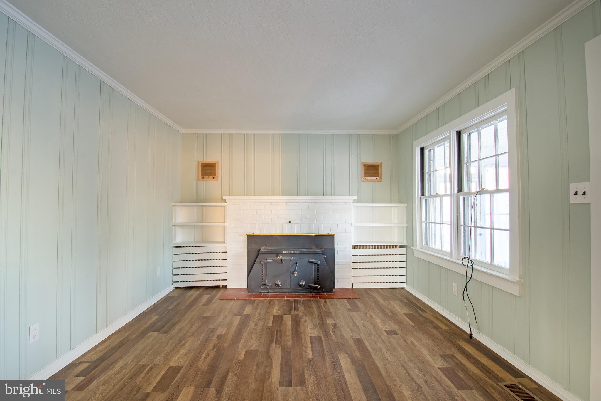25165 Prettyman Road Georgetown, DE 19947 - Photo 12 of 43 an empty room with windows and fireplace