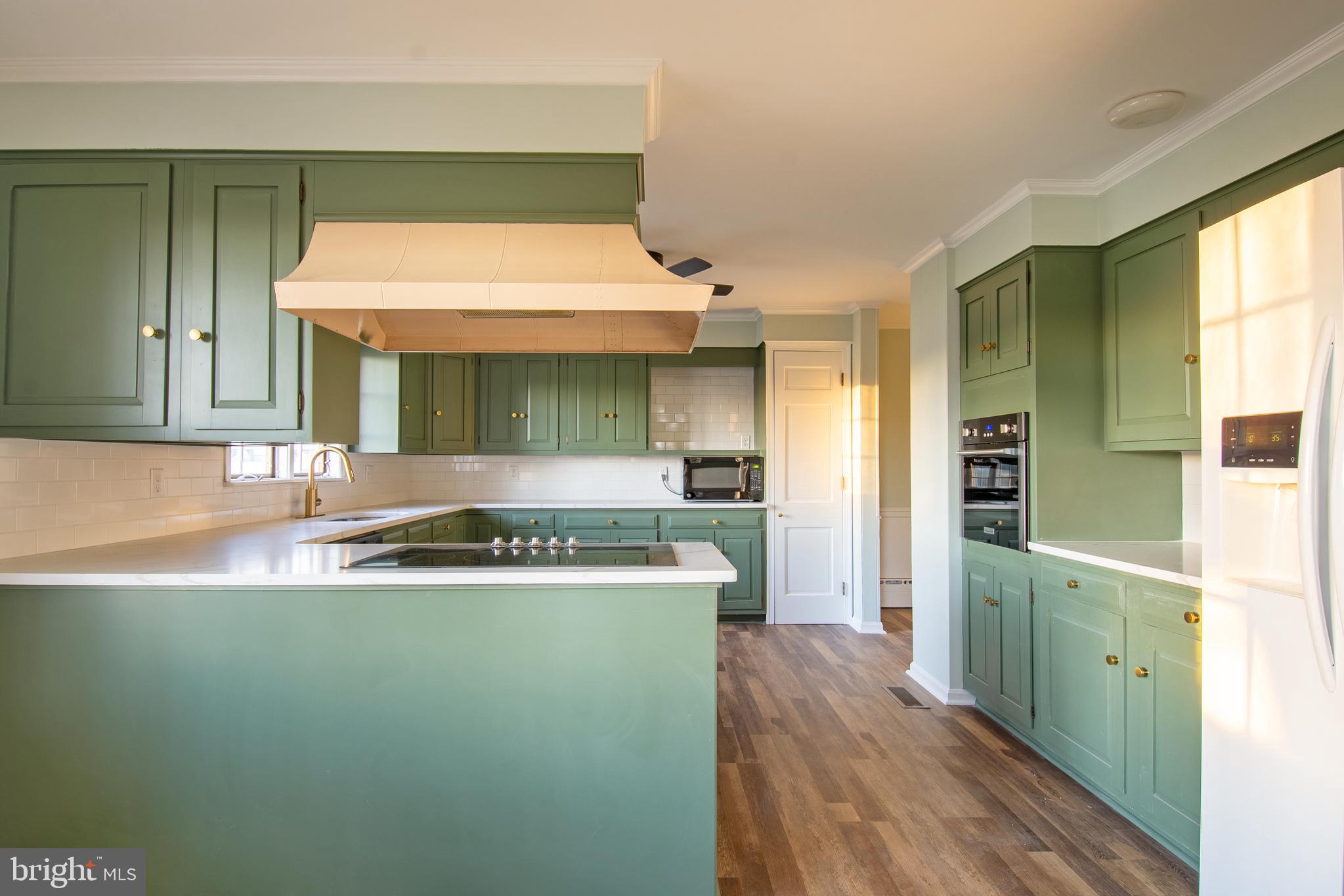 25165 Prettyman Road Georgetown, DE 19947 - Photo 17 of 43 a kitchen with kitchen island a sink stove and refrigerator