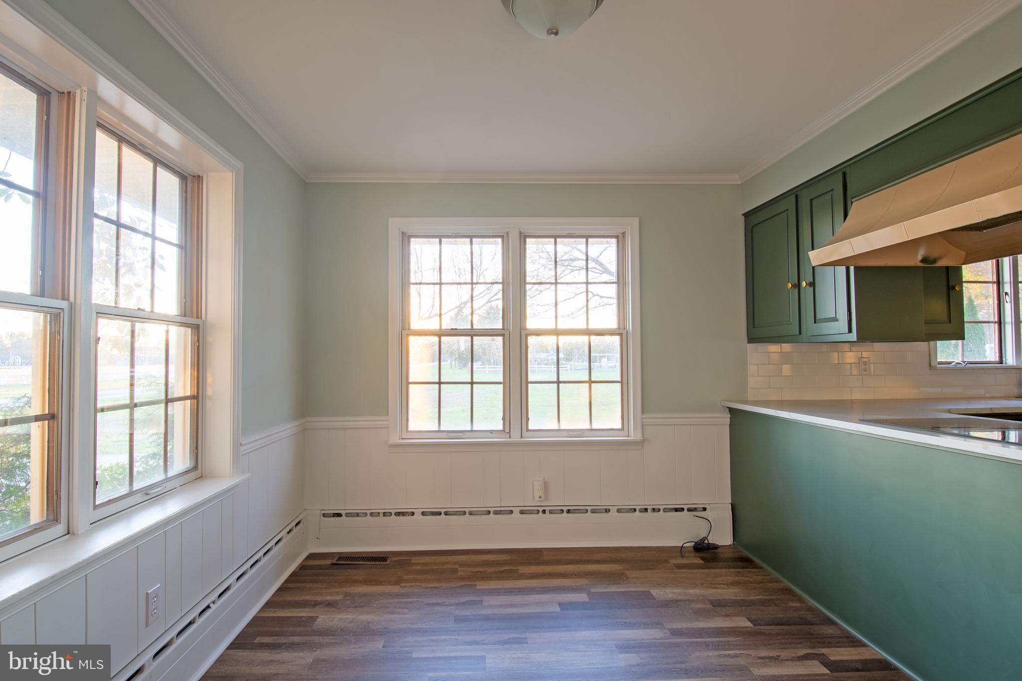 25165 Prettyman Road Georgetown, DE 19947 - Photo 18 of 43 an empty room with wooden floor and windows