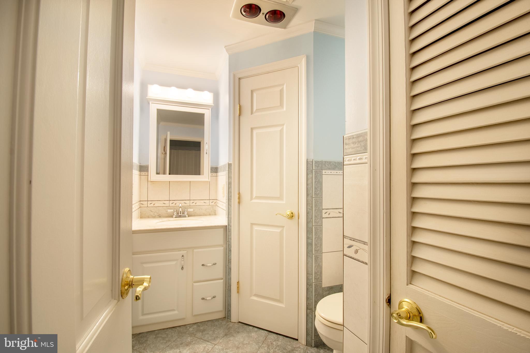 25165 Prettyman Road Georgetown, DE 19947 - Photo 20 of 43 a bathroom with a sink and a mirror