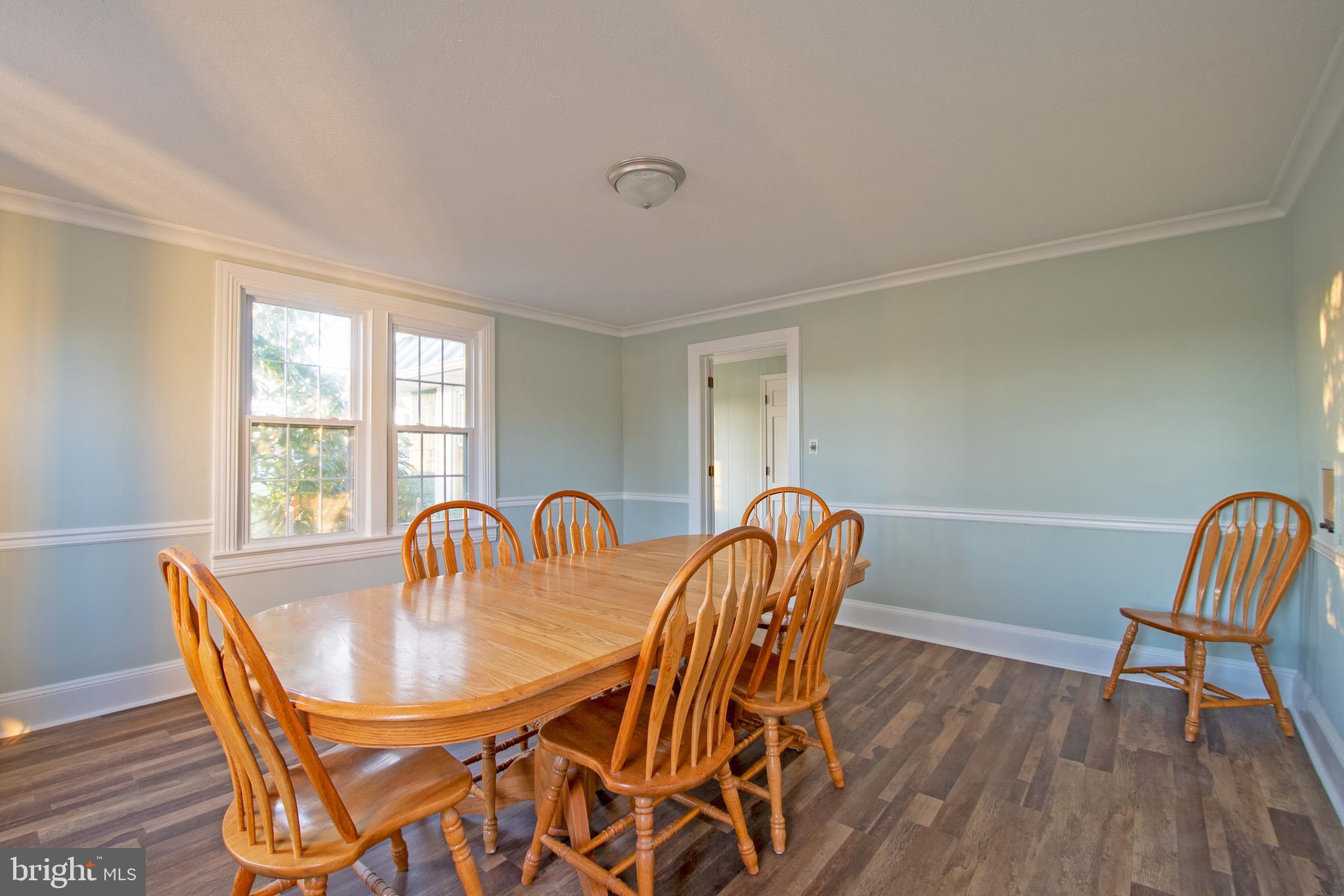 25165 Prettyman Road Georgetown, DE 19947 - Photo 23 of 43 a dining room with furniture and wooden floor