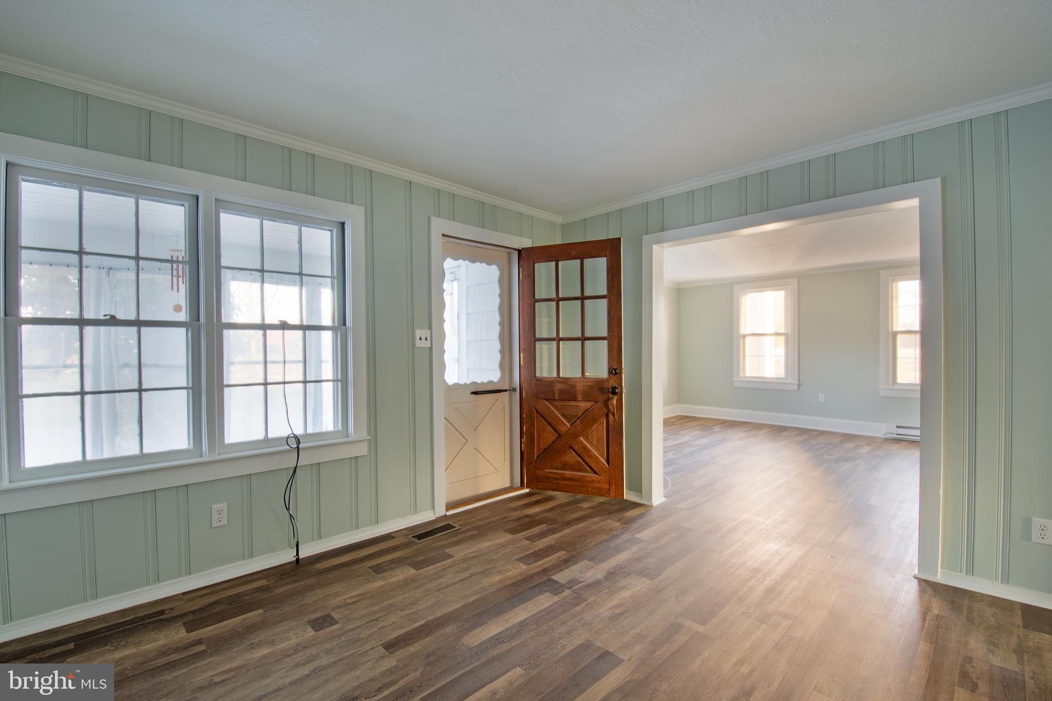 25165 Prettyman Road Georgetown, DE 19947 - Photo 24 of 43 an empty room with wooden floor and windows