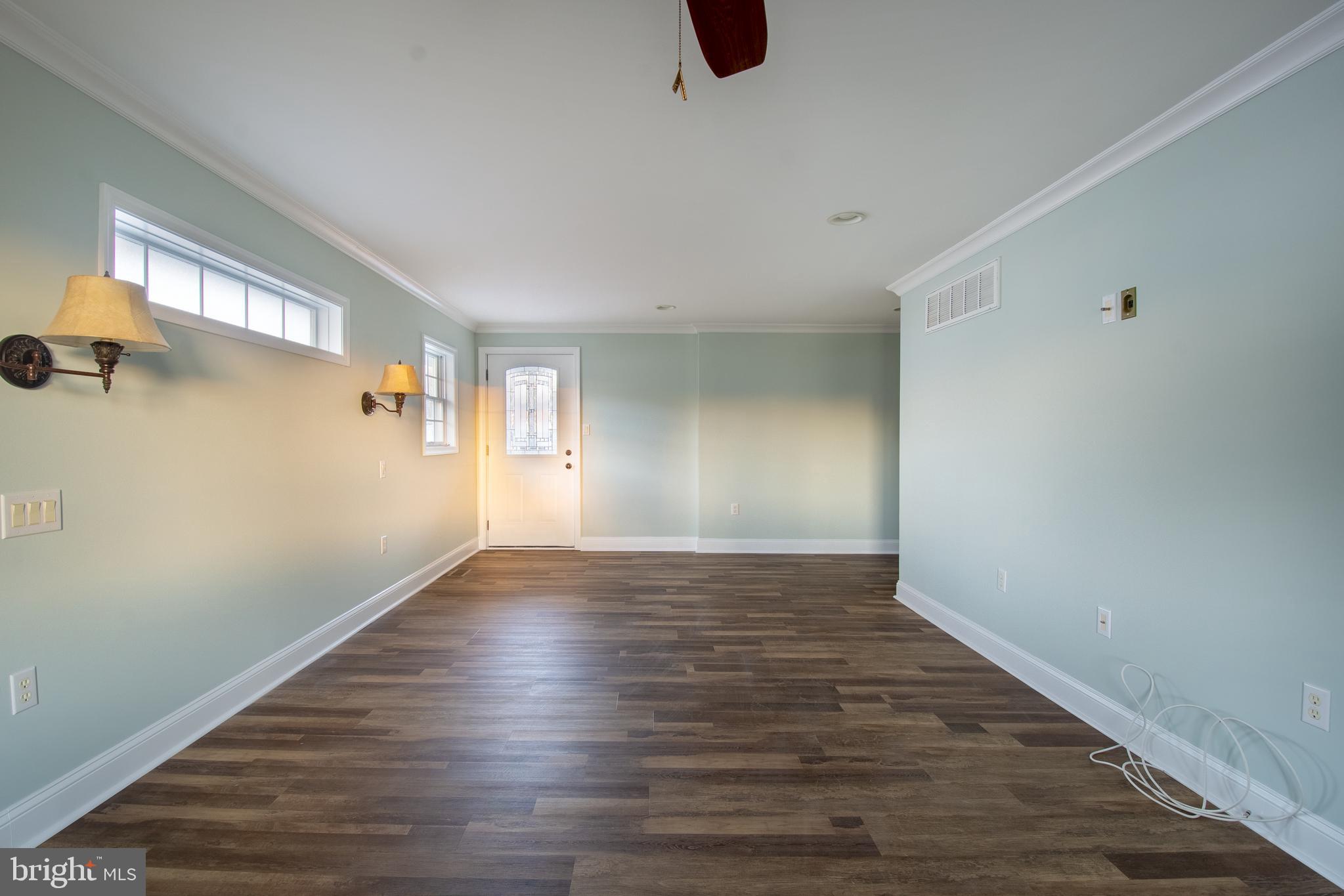 25165 Prettyman Road Georgetown, DE 19947 - Photo 27 of 43 a view of an empty room with wooden floor and a window