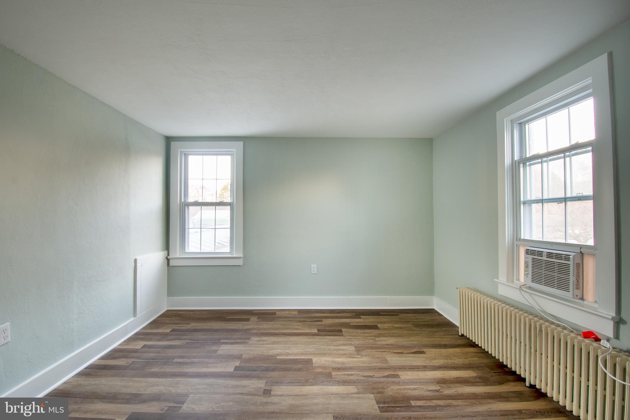 25165 Prettyman Road Georgetown, DE 19947 - Photo 35 of 43 a view of an empty room with wooden floor and a window