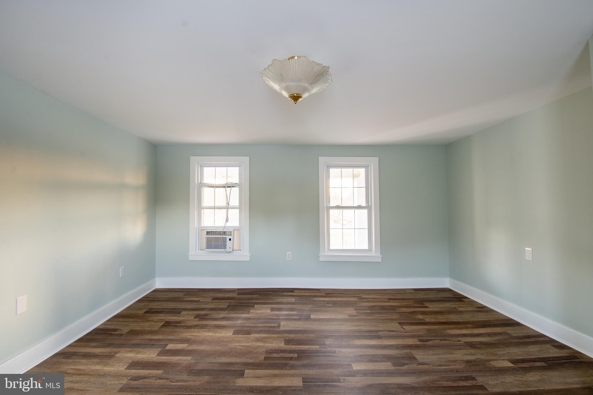 25165 Prettyman Road Georgetown, DE 19947 - Photo 38 of 43 a view of an empty room with wooden floor and a window