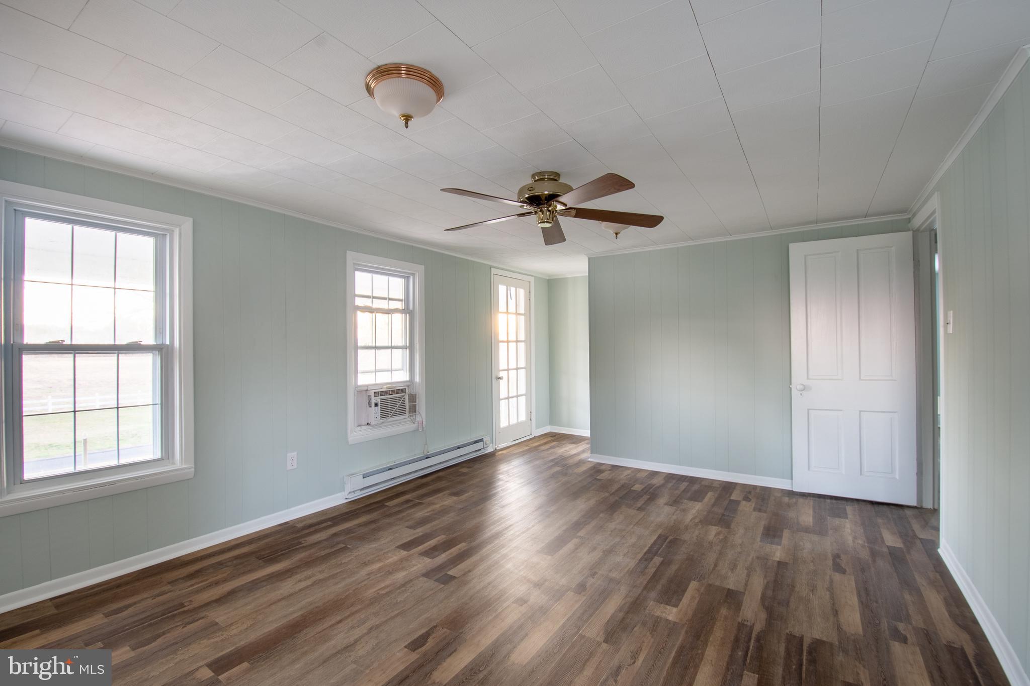 25165 Prettyman Road Georgetown, DE 19947 - Photo 39 of 43 an empty room with wooden floor and windows