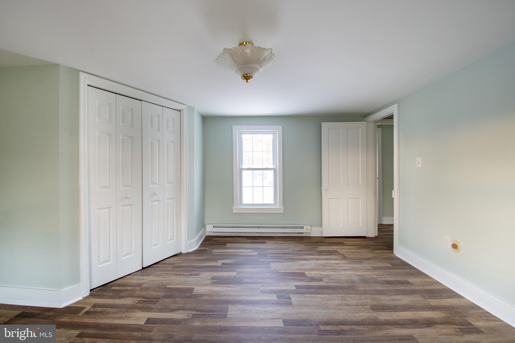 25165 Prettyman Road Georgetown, DE 19947 - Photo 40 of 43 an empty room with wooden floor and windows
