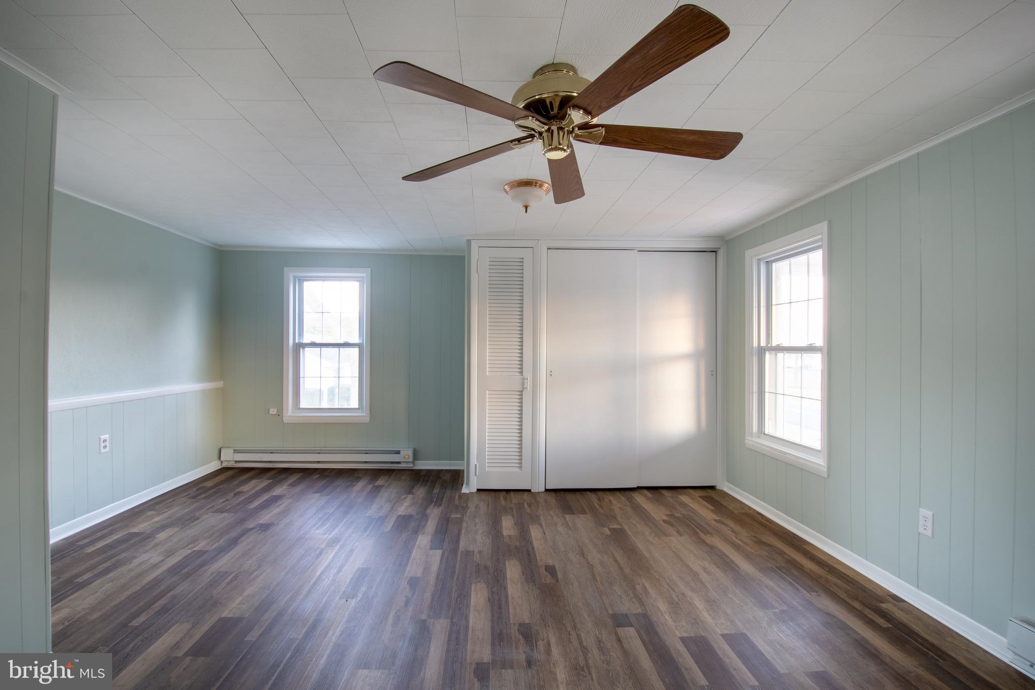25165 Prettyman Road Georgetown, DE 19947 - Photo 41 of 43 a view of empty room with wooden floor and fan