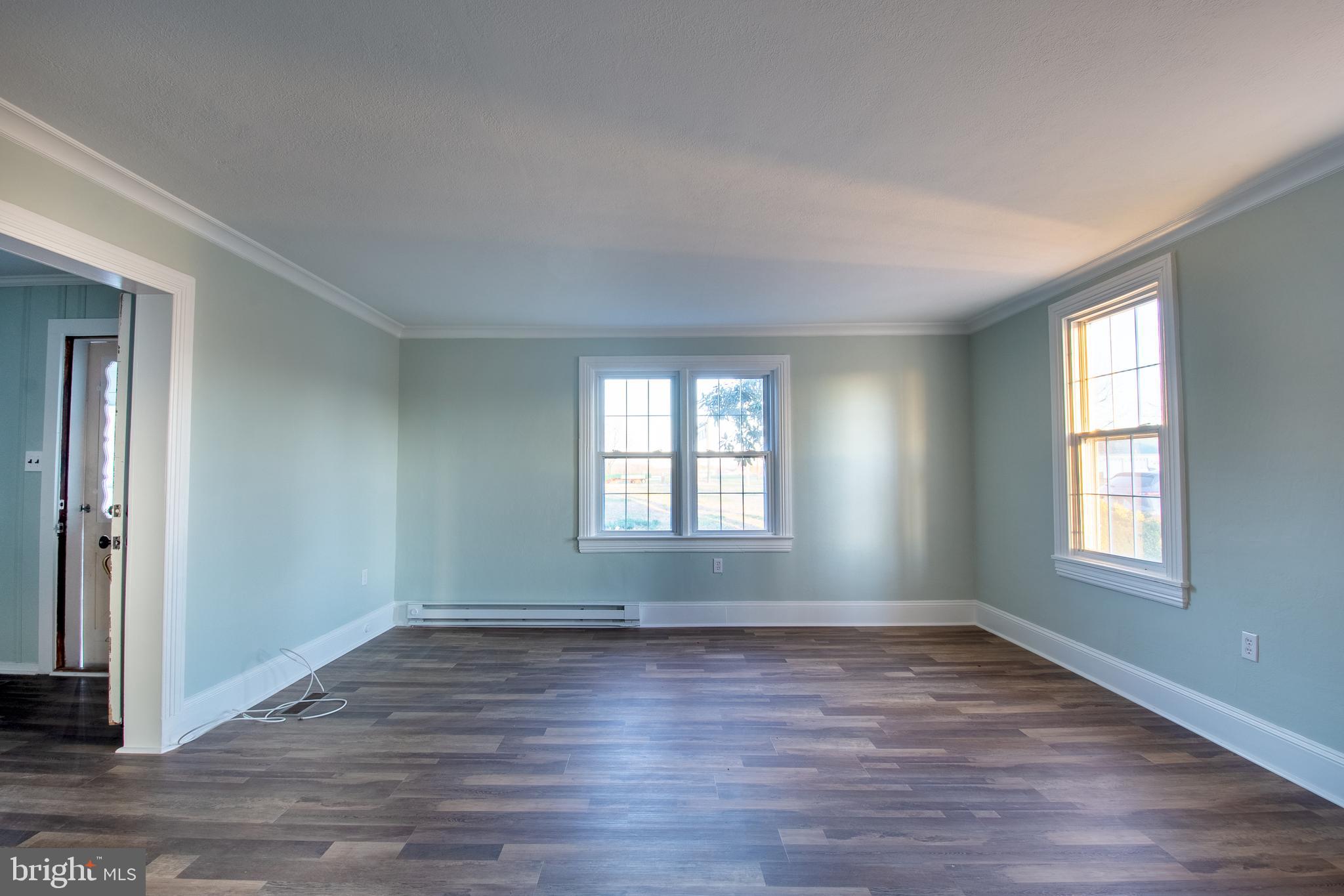 25165 Prettyman Road Georgetown, DE 19947 - Photo 10 of 43 an empty room with wooden floor and windows