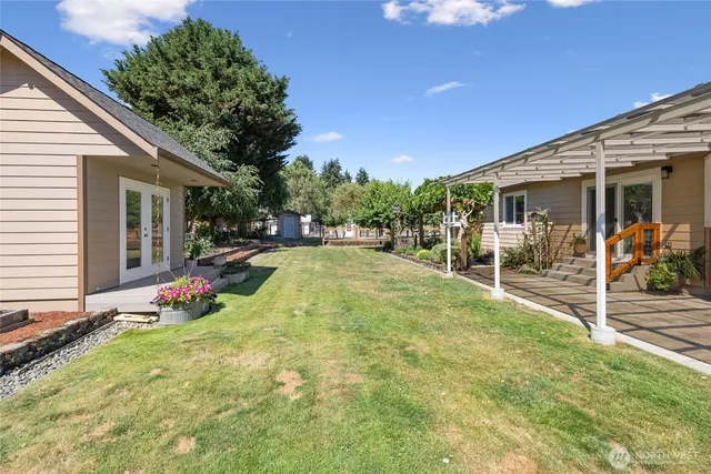 a view of a house with backyard and sitting area