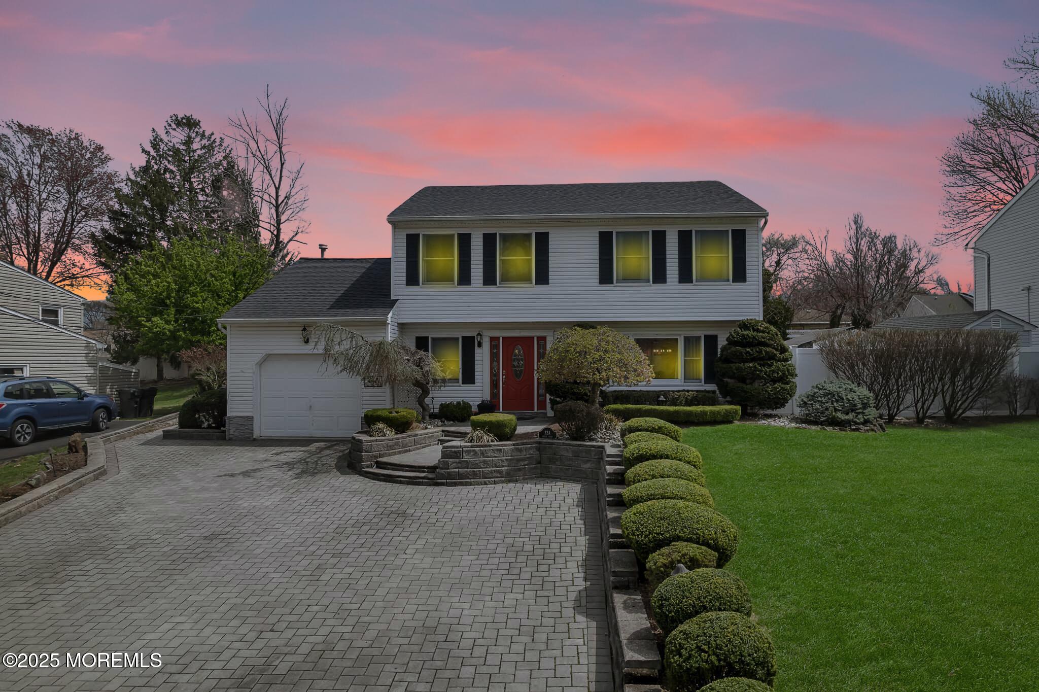 22 A Bedle Road Hazlet, NJ 07730 - Photo 28 of 32 a front view of a house with a garden and sitting area
