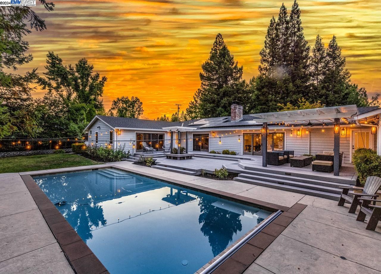 a front view of house with yard and outdoor seating