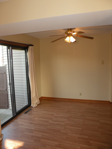 250 Circlegate Road, Unit 250 New Lenox, IL 60451 - Photo 3 of 25 a view of an empty room with wooden floor and a window