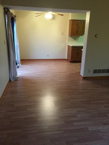 250 Circlegate Road, Unit 250 New Lenox, IL 60451 - Photo 5 of 25 a view of an empty room with wooden floor and a window