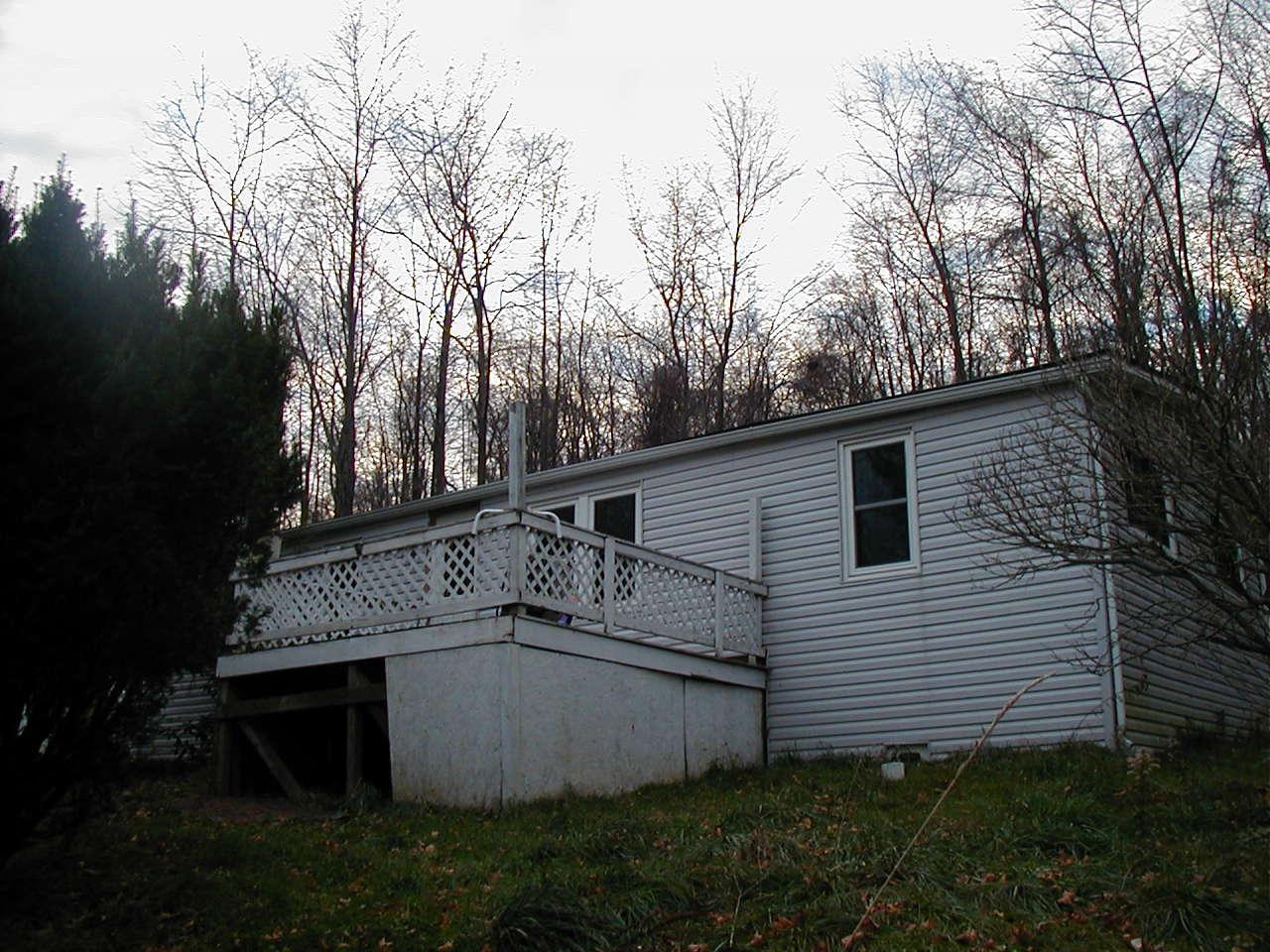 1069 Cortez Road Lake Ariel, PA 18436 - Photo 1 of 1 a view of a white house with a large tree and a yard