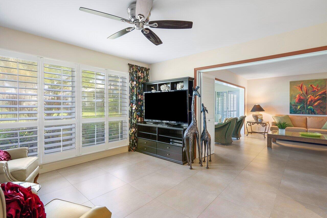 3677 Quail Ridge Drive, Unit BOBWHITE B Boynton Beach, FL 33436 - Photo 12 of 47 a living room with furniture and a flat screen tv