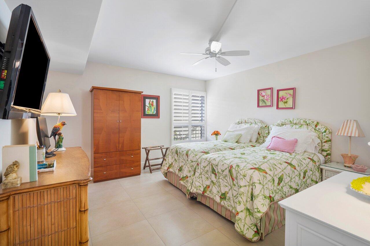 3677 Quail Ridge Drive, Unit BOBWHITE B Boynton Beach, FL 33436 - Photo 17 of 47 a bedroom with a bed and a flat tv screen on dresser