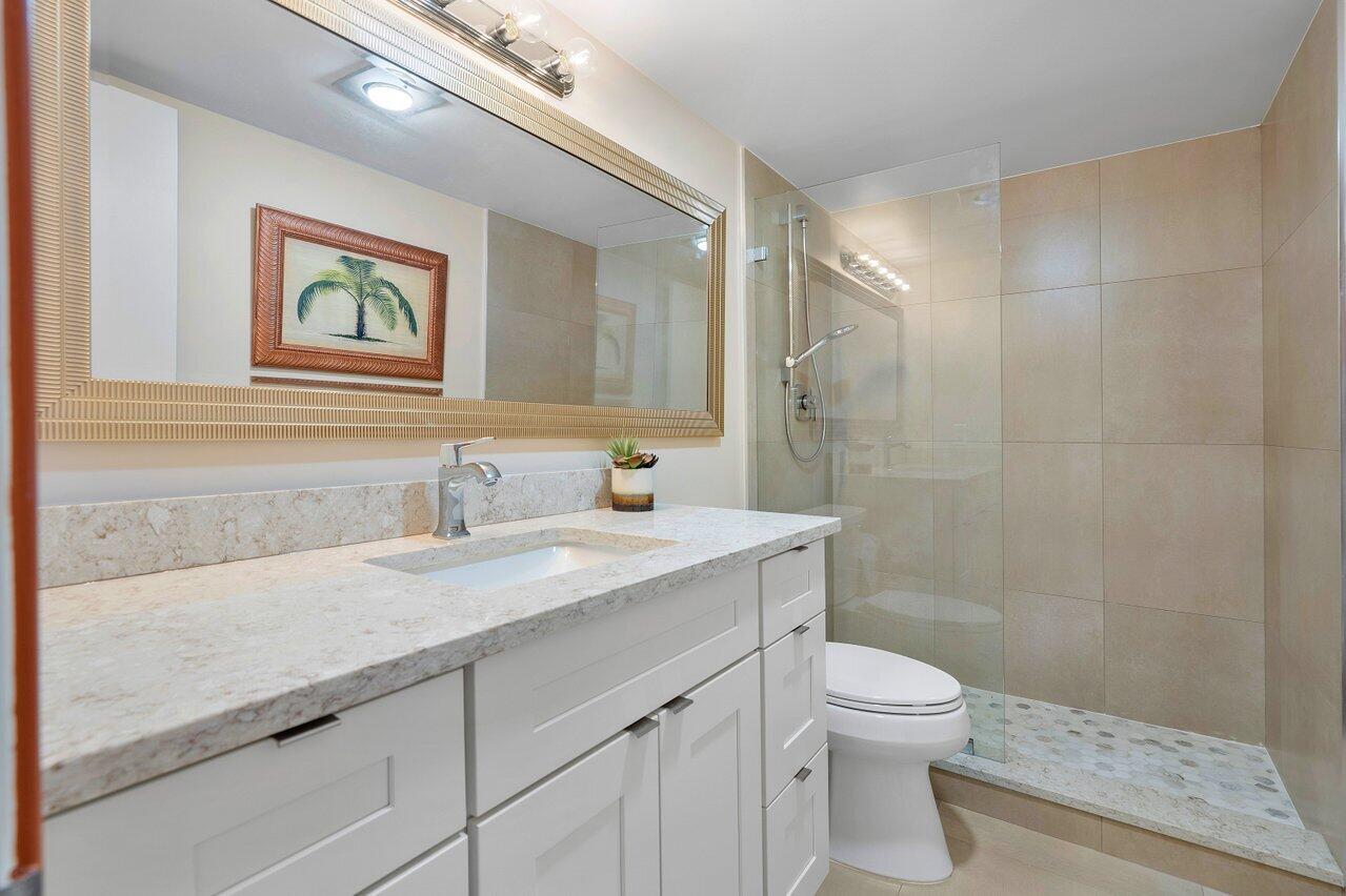 3677 Quail Ridge Drive, Unit BOBWHITE B Boynton Beach, FL 33436 - Photo 18 of 47 a bathroom with a granite countertop sink mirror vanity and toilet