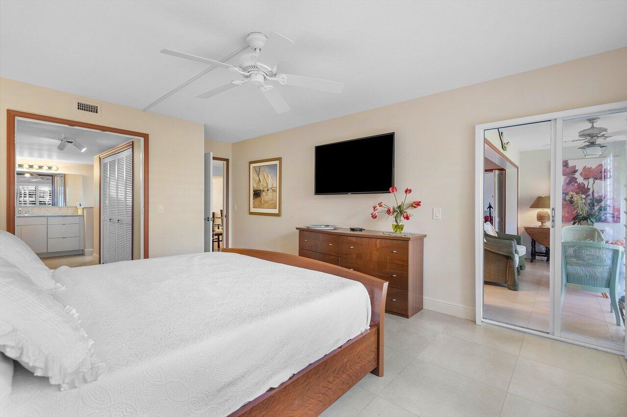 3677 Quail Ridge Drive, Unit BOBWHITE B Boynton Beach, FL 33436 - Photo 20 of 47 a bedroom with a bed and a flat screen tv
