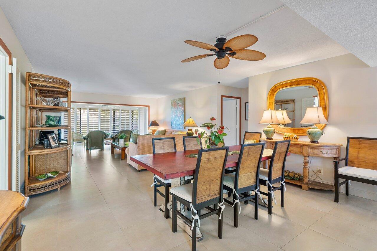 3677 Quail Ridge Drive, Unit BOBWHITE B Boynton Beach, FL 33436 - Photo 2 of 47 a view of a dining room with furniture and wooden floor