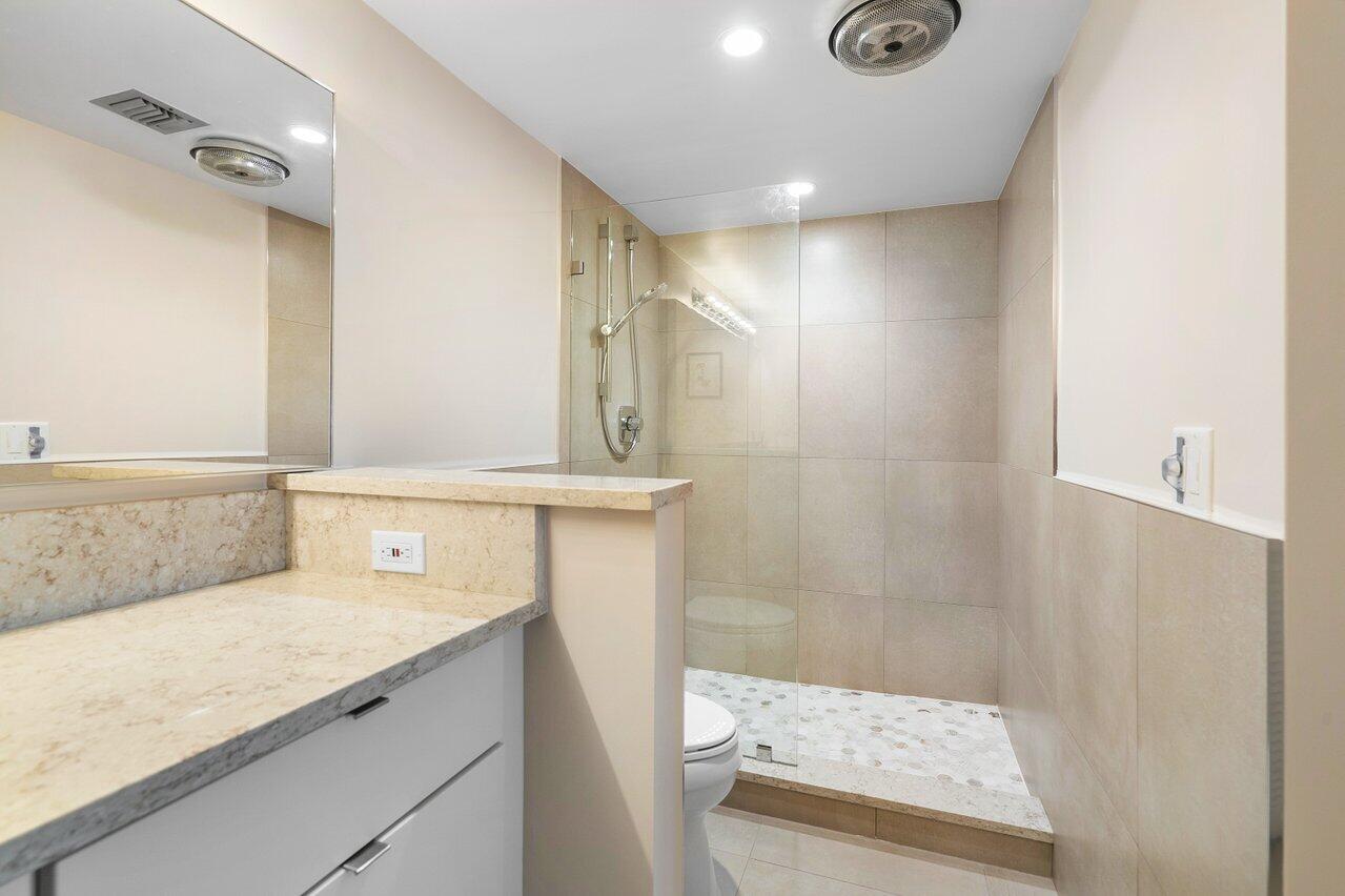 3677 Quail Ridge Drive, Unit BOBWHITE B Boynton Beach, FL 33436 - Photo 22 of 47 a bathroom with a shower and a sink