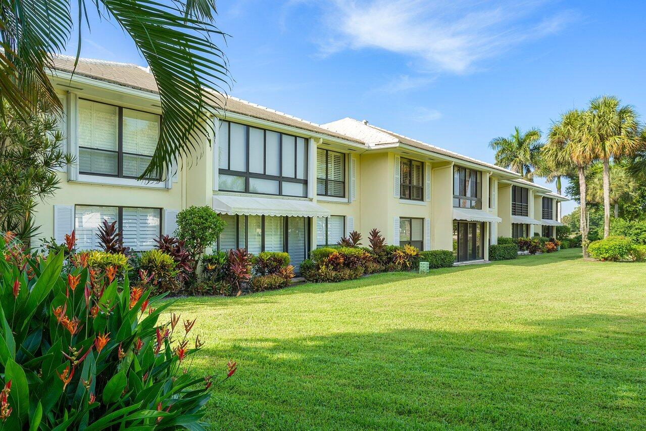 3677 Quail Ridge Drive, Unit BOBWHITE B Boynton Beach, FL 33436 - Photo 25 of 47 a view of a house with a yard