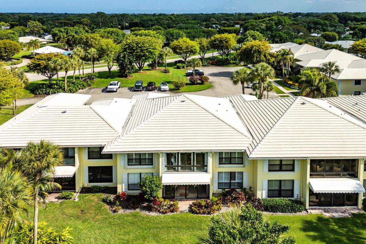 3677 Quail Ridge Drive, Unit BOBWHITE B Boynton Beach, FL 33436 - Photo 30 of 47 an aerial view of a house with a yard and potted plants