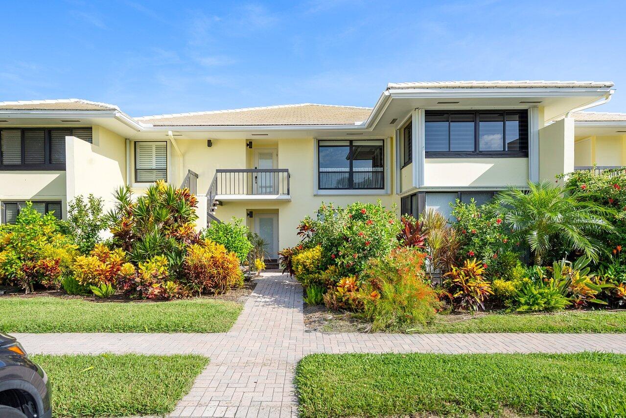 3677 Quail Ridge Drive, Unit BOBWHITE B Boynton Beach, FL 33436 - Photo 35 of 47 a front view of a house with a yard